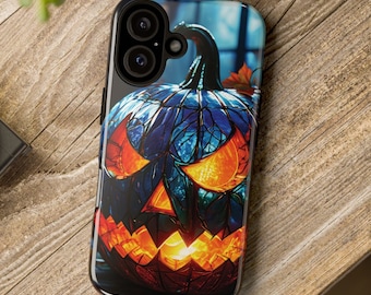May include: A black phone case featuring a stained-glass style jack-o'-lantern design. The pumpkin has a blue body with orange glowing eyes and mouth. A dark stem and a red leaf are visible on top of the pumpkin.