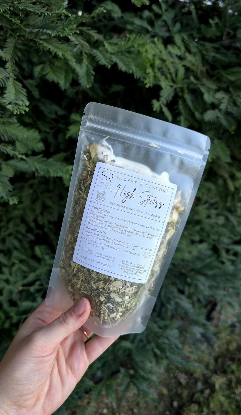 May include: A clear plastic bag of herbal tea blend labeled "Soothe & Restore High Stress." The bag contains dried herbs and flowers. The label includes directions and ingredients. The net weight is 1.4 oz.