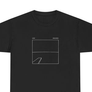 May include: Black t-shirt with a white graphic design. The design features a rectangular shape with a horizontal line and a diagonal line. The text "CLUTTER" and "GREATEST WEAKER" are above the graphic.
