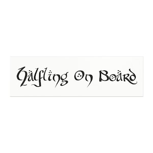 May include: A rectangular white sticker with the words "Halfling On Board" in black, stylized lettering. The text has a fantasy or medieval aesthetic, with decorative elements. The sticker is designed to be placed on a vehicle.