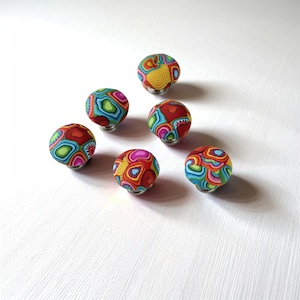 a group of colorful balls sitting on top of a white table