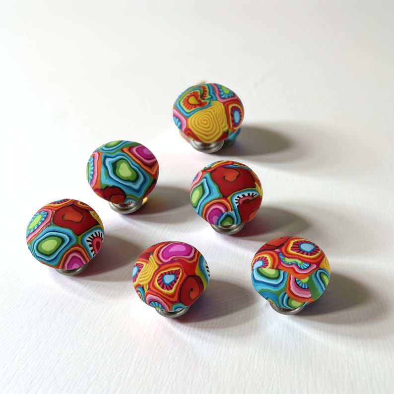 a group of colorful balls sitting on top of a white table