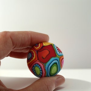 a person holding a colorful object in their hand