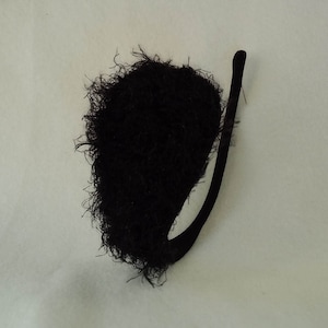 May include: Black fuzzy tail costume accessory with a black felt tail.