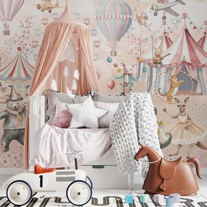 May include: A children's bedroom with a circus theme, featuring a white bed, pink canopy, and wallpaper with circus animals and hot air balloons. Includes a white toy car, a brown rocking horse, and a road-patterned rug. Soft furnishings complete the scene.