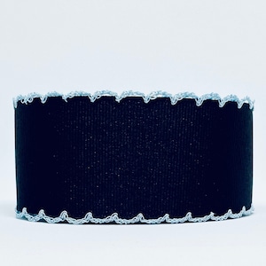 May include: Black ribbon with a light blue scalloped edge.