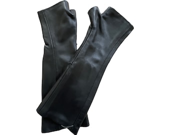 May include: A pair of black leather fingerless gloves. The gloves are folded in half and the fingertips are visible.