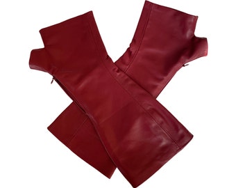 May include: A pair of red leather boot cuffs. The cuffs are made of a soft, supple leather and have a simple, elegant design.