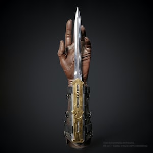 May include: A set of three ceramic mugs with a speckled, matte finish. The mugs are in shades of cream, light gray, and dark gray. Each mug has a simple, minimalist design, perfect for coffee or tea.