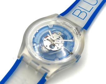 Reloj Swatch Jelly en color Jelly FLUID WORD SUJK104 - sin usar, en perfecto estado - batería nueva - 38 mm, nuevo en caja. Reloj Swatch del año 2006.