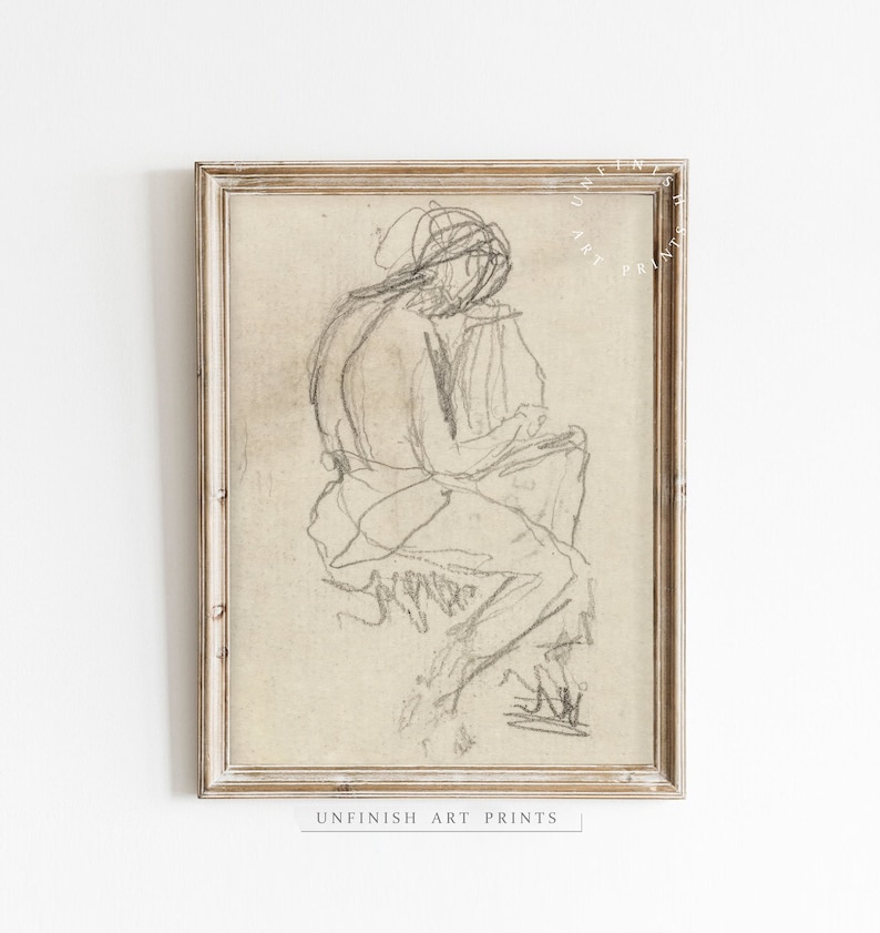 May include: A black and white pencil sketch of a person sitting in a chair, framed in a light wood frame. The artwork is titled "Unfinish Art Prints".