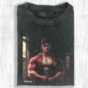 May include: Dark gray t-shirt featuring a stylized illustration of a muscular man wearing glasses and a red shirt. The image includes the name "Harry" at the bottom. The shirt has a crew neck.