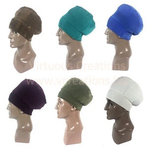 May include: Six beanies in various colors: brown, teal, blue, purple, olive green, and white. Each beanie is displayed on a mannequin head, showcasing the hat's shape and fit. The hats are made of a soft material and are suitable for casual wear.