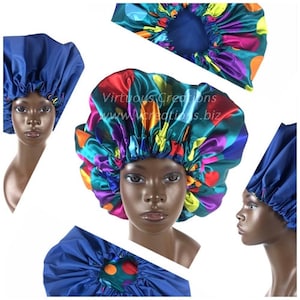 May include: A collection of satin hair bonnets in various colors and patterns. One bonnet is a solid navy blue, while others feature vibrant designs with red, yellow, purple, and teal. The bonnets are displayed on mannequin heads against a white background.