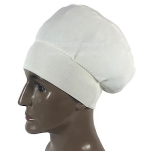 May include: White chef hat with a wide brim and a snug fit. The hat is made of a soft, breathable fabric.
