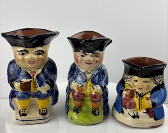 Three antique Torquay Pottery Toby Jugs.