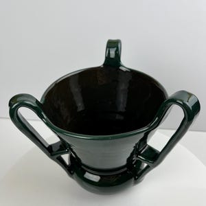 CH Brannam of Barnstaple antique 1920’s Art Deco three handled vase in a deep green glaze. +6” tall.