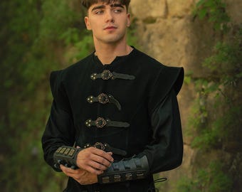 May include: Black medieval-style tunic with decorative clasps and matching wrist cuffs. The tunic features a high collar and shoulder pads. The Rawblade logo is visible at the bottom right.