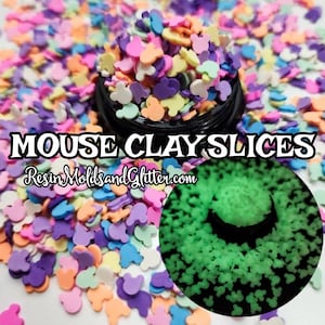 May include: A close-up of a jar filled with colorful mouse-shaped clay slices. The jar is surrounded by more clay slices, some of which are glowing green in the dark. The text "MOUSE CLAY SLICES" and "ResinMoldsandGlitter.com" is visible on the image.
