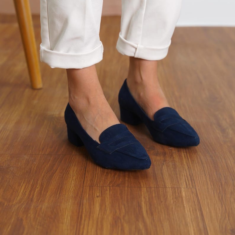 Front view of a woman standing in navy blue vegan suede low block heel loafers, capturing the sophisticated look and sleek design hyl wedding short heels.