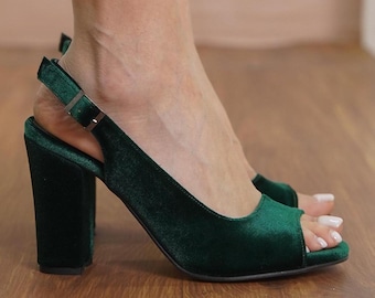 May include: Green velvet peep-toe heels with a chunky block heel and an ankle strap.