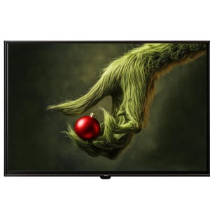 May include: A flat-screen television displays a whimsical image of a green, furry hand holding a red Christmas ornament. The background is a dark, blurred green, creating a festive holiday theme.