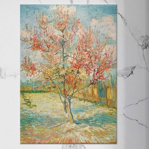 May include: A framed print of a painting showing a flowering tree with pink and red blossoms against a blue sky. The artwork features a tree with a light brown trunk and branches, set in a field with a wooden fence.