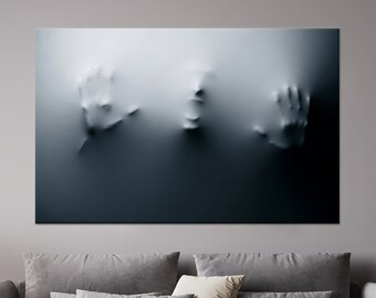 May include: A black and white abstract art print featuring a face and two hands emerging from a textured surface.