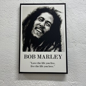 May include: Black and white portrait of Bob Marley with the quote "Love the life you live, live the life you love."