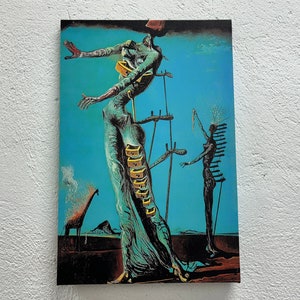 May include: A surrealist painting featuring two figures with elongated limbs. The figure on the left is a woman with a long, flowing dress and a series of drawers on her torso. The figure on the right is a woman with a crown of thorns and a series of spikes on her back. The background is a vibrant blue.
