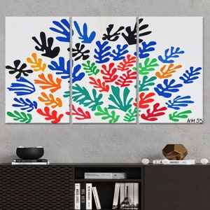 May include: A three-panel canvas print featuring a colorful abstract design of stylized leaves in shades of blue, green, orange, red, and black. The print is signed "HM 53" in the bottom right corner.