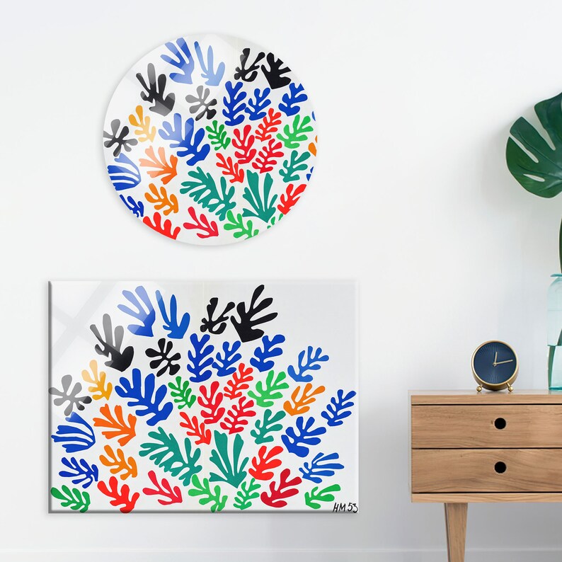 May include: A colorful abstract art print featuring a cluster of blue, green, red, orange, and black leaves. The print is on a white background and has the artist's signature "HM 53" in the bottom right corner.
