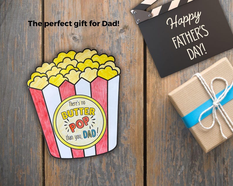 May include: A colorful, hand-drawn popcorn box with the text "There's no BUTTER POP than you, DAD!" on a yellow circle. A black clapperboard with "Happy FATHER'S DAY!" and a wrapped gift with a blue ribbon are also visible.
