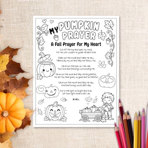 以下が含まれることがあります： My Pumpkin Prayer, A Fall Prayer for My Heartというタイトルの白黒の印刷可能な塗り絵ページ。テキスト、カボチャ、子供、秋の葉のイラストが描かれており、オレンジ色のカボチャと色鉛筆に囲まれています。