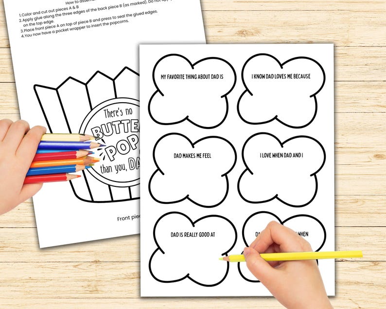 May include: Two sheets of white paper with black outlines for a Father's Day craft. One sheet has a popcorn bucket design with the text "There's no BUTTER POP than you, DAD". The other sheet has six cloud-shaped prompts.