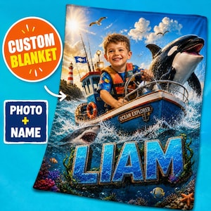 May include: A custom blanket featuring a child steering a blue boat labeled Ocean Explorer, accompanied by an orca and a shark in the ocean. The design includes the name LIAM in large blue letters, a lighthouse, seagulls, and coral reef elements.