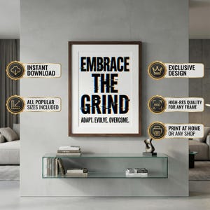 May include: A framed print with the text "EMBRACE THE GRIND" in a bold, glitch-style font. Below the title are the words "ADAPT. EVOLVE. OVERCOME." The print is displayed on a gray wall above a glass shelf with books and a sculpture.