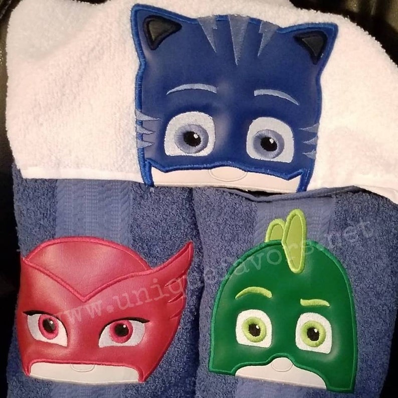 Masks inspired characters with optional personalization. Hooded towels or other items available. 3 characters to choose from image 1