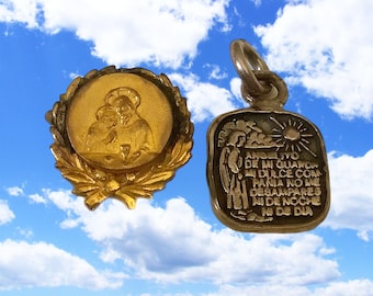 May include: Two vintage religious pendants. One is gold-toned, circular, and features a relief of two figures within a laurel wreath. The other is silver-toned, rectangular, and has engraved text and imagery of a sun and clouds.