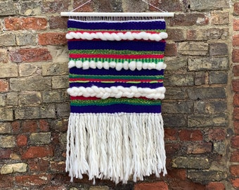 Chunky funky woven wall hanging in greens, purples, pinks and natural.