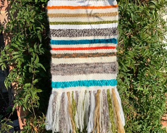 Striped textured handwoven tapestry wall hanging with fringing. A simple modern piece of textile art for your space.