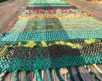 Table runner handwoven in forest colours, greens, natural.