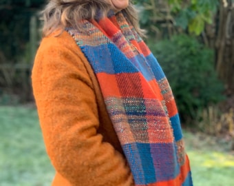 Handwoven scarf made with handspun yarns, chunky and wide and colourful. Oranges and blues