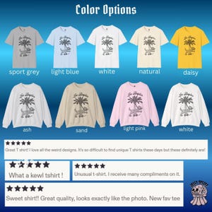 May include: A selection of t-shirts and sweatshirts in colours such as sport grey, light blue, white, natural, and daisy. Each item displays a graphic of a dog with a palm tree and the text "Los Angeles".