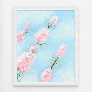 May include: A framed painting of pink flowers against a light blue sky. The flowers are in clusters and have green stems and leaves.