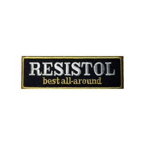 May include: A rectangular patch with the word "RESISTOL" in white capital letters above "best all-around" in gold. The patch has a black background with a gold border.