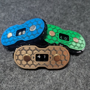 May include: Three counter dials with a honeycomb pattern. The dials are blue, green, and brown. The numbers on the dials read 40, 40, and 41.