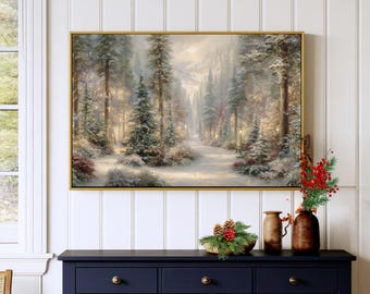 May include: A rectangular framed wall art print depicting a snowy forest landscape with tall evergreen trees and a path. Below the art, a dark blue wooden cabinet holds a brown vase and a decorative arrangement of pine needles and red berries.