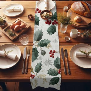 May include: A festive table setting with a white holly-patterned table runner. The table is set with plates, silverware, and rolled napkins. A wooden tray holds eggs and greenery. A loaf of bread and other dishes complete the holiday scene.
