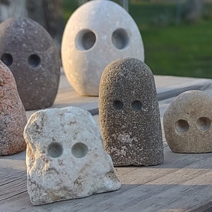 funny cute art rock set, grey and pink and white limestone, minimalist eye holes excavated with high speed drill